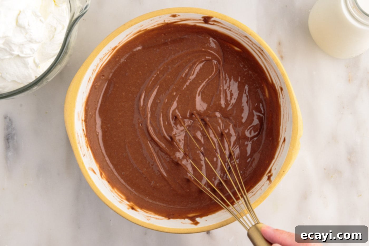 Decadent Brownie Trifle 7 Vigorously whisking instant chocolate pudding mix and milk in a bowl until it starts to thicken.