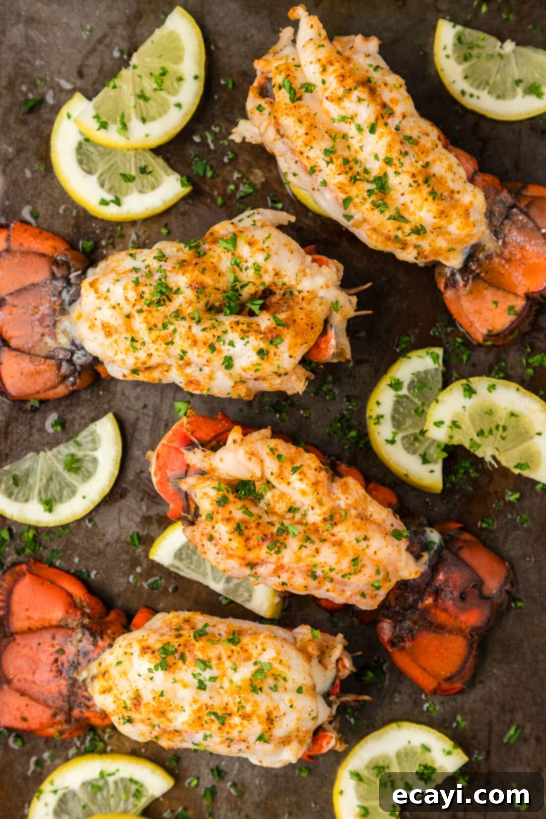 Golden Baked Lobster 2 Baked Lobster Tails on a baking sheet with lemons