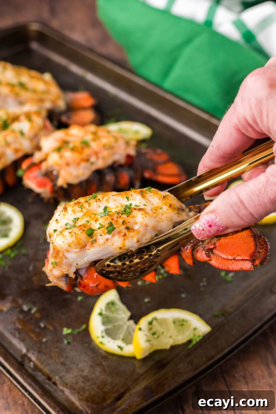 Golden Baked Lobster 3 Tongs lifting up a Baked Lobster Tail