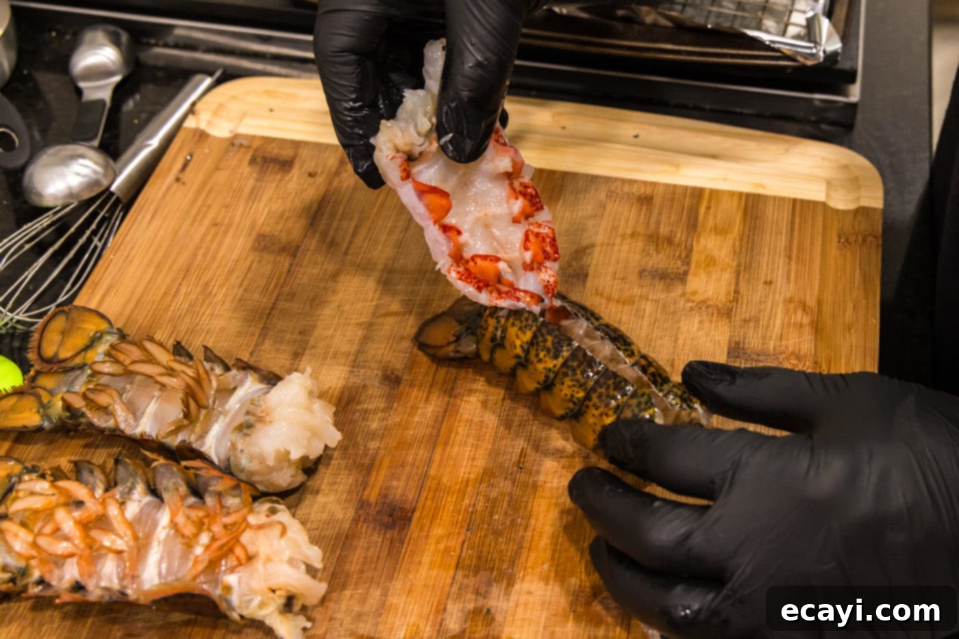 Golden Baked Lobster 8 hand pulling lobster meat out of shell