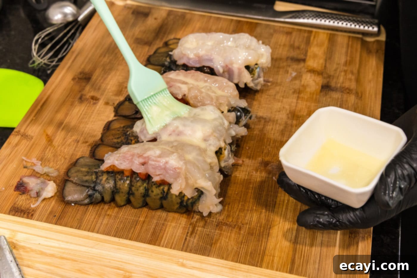 Golden Baked Lobster 10 brushing crowned lobsters with melted butter