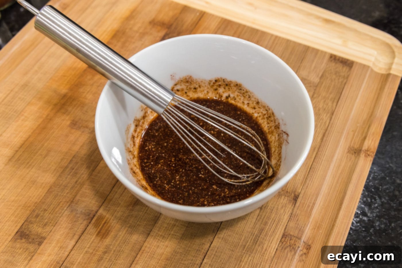 Crispy Golden Cornish Hens 6 cornish hen wet rub being whisked in a bowl