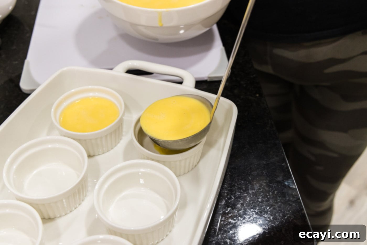 Creme Brulee 15 ladle pouring creme brulee filling into a ramekin
