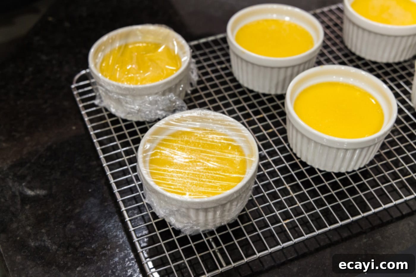 Creme Brulee 19 plastic wrap covering custard in a ramekins
