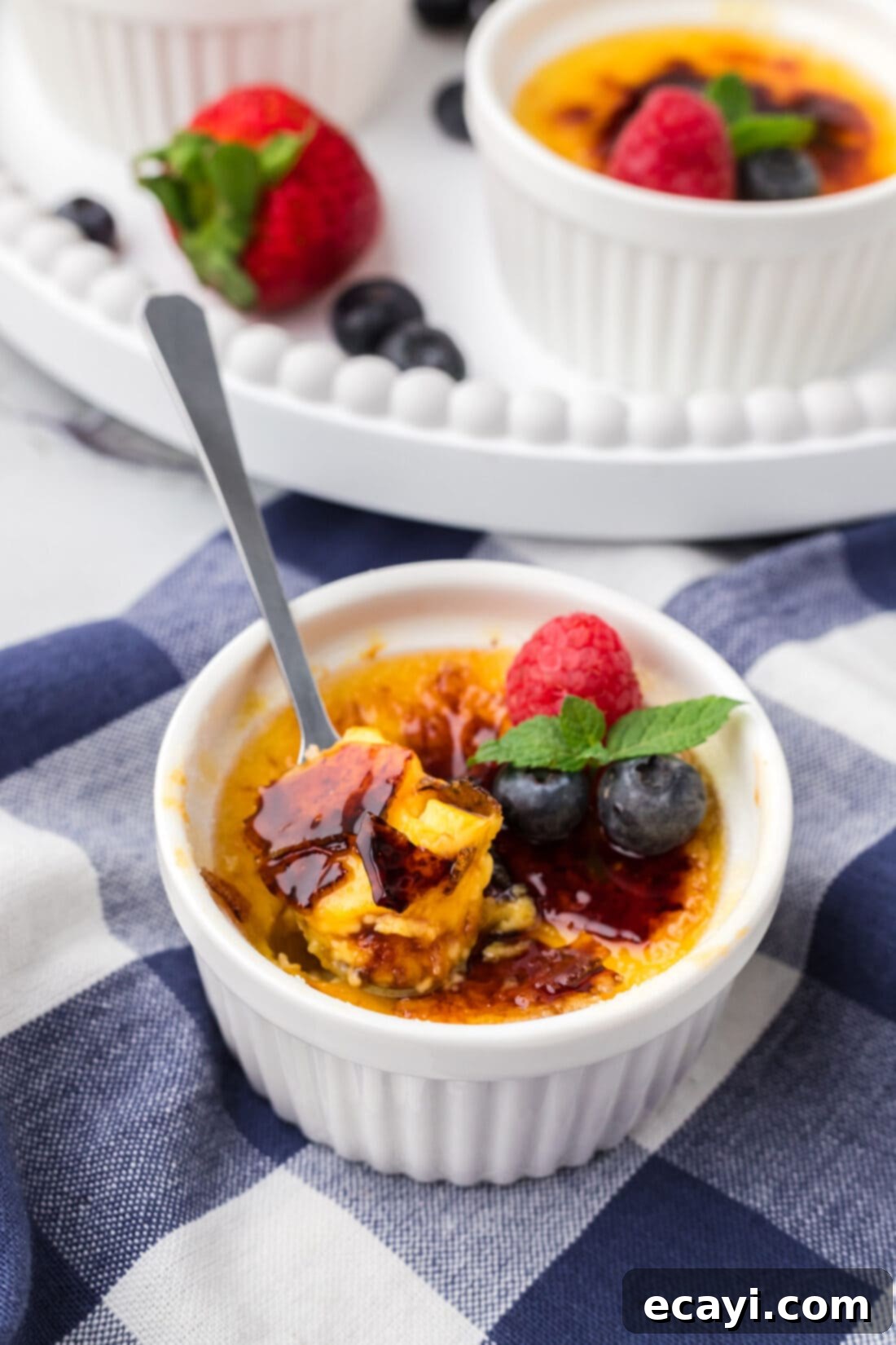 Creme Brulee 22 Spoonful of Creme Brulee sitting in a ramekin of Creme Brulee