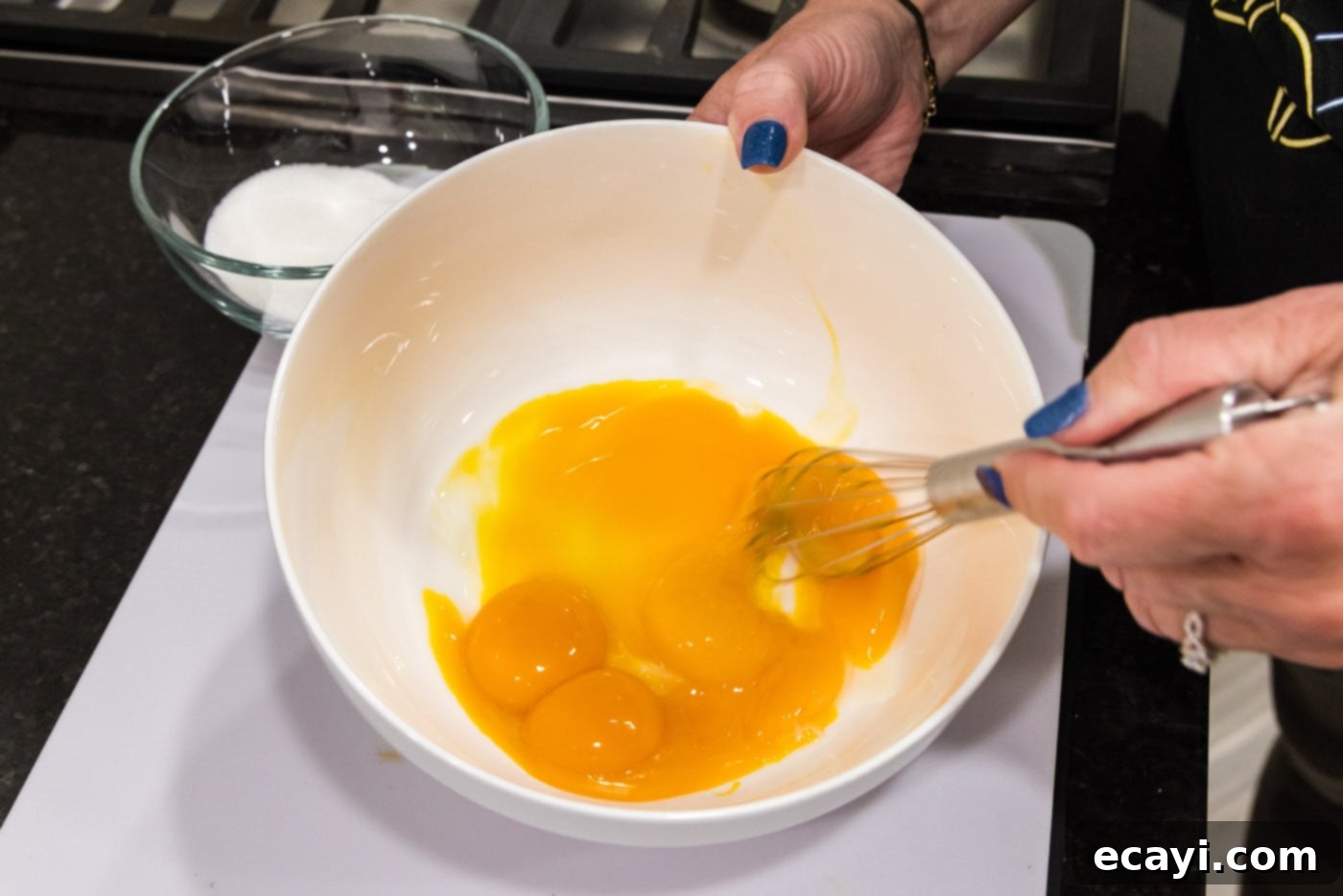 Creme Brulee 10 whisking egg yolks in a bowl