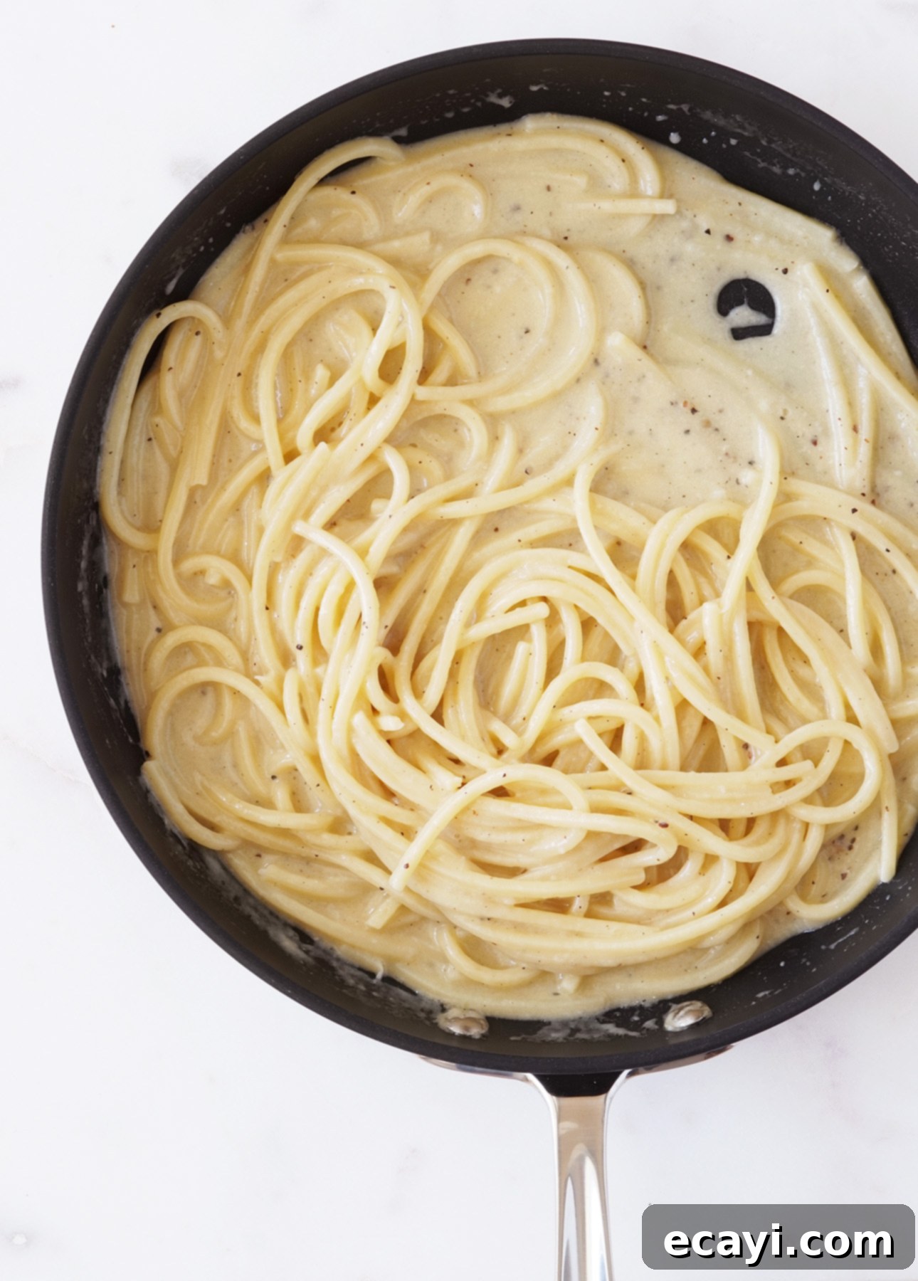 The Secret to Perfect Cacio e Pepe 5 A skillet filled with freshly made Cacio e Pepe, a classic Roman pasta recipe