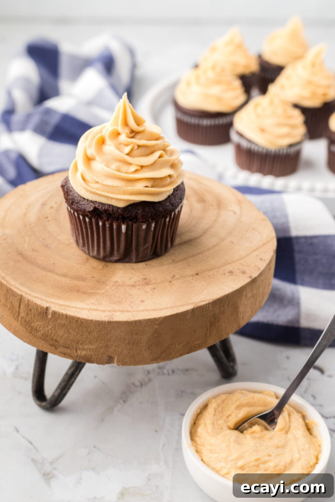Peanut Butter Bliss 2 Cupcakes topped with Peanut Butter Frosting and a bowl of frosting on the side