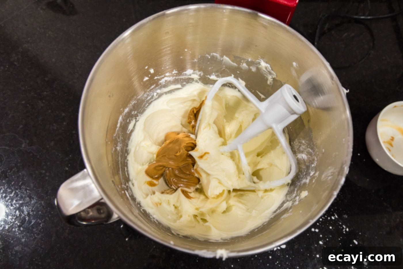 Peanut Butter Bliss 9 peanut butter added to cream cheese frosting in a bowl of a stand mixer