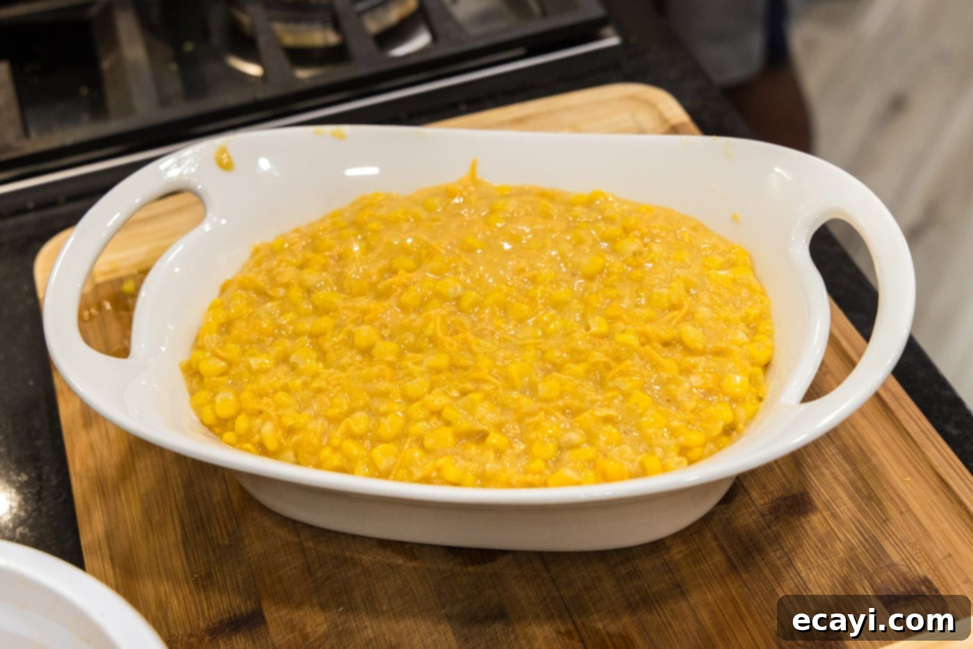 Creamy Baked Corn 11 The assembled scalloped corn mixture poured into a baking dish, ready for topping