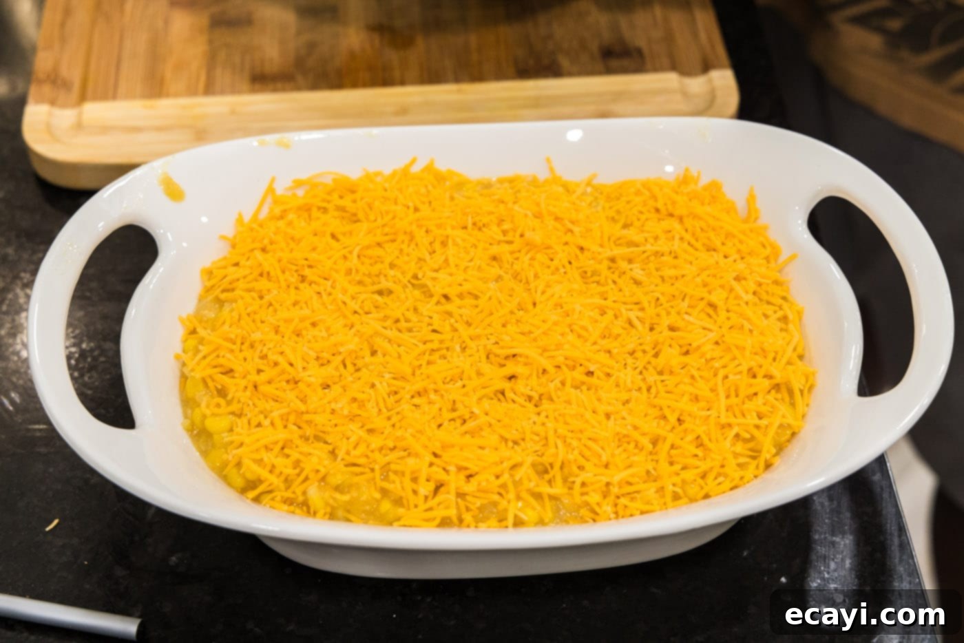Creamy Baked Corn 12 More shredded cheddar cheese sprinkled evenly over the top of the scalloped corn casserole mixture