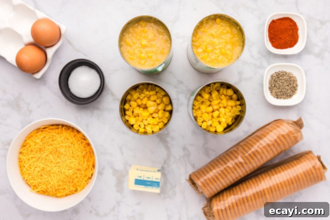 Creamy Baked Corn 4 A flat lay photograph showcasing all the fresh and canned ingredients needed for making Scalloped Corn Casserole, including corn, cheese, eggs, and crackers
