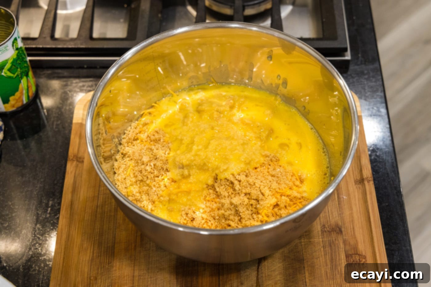 Creamy Baked Corn 10 Reserved buttery Ritz cracker crumbs being added to the corn and cheese mixture