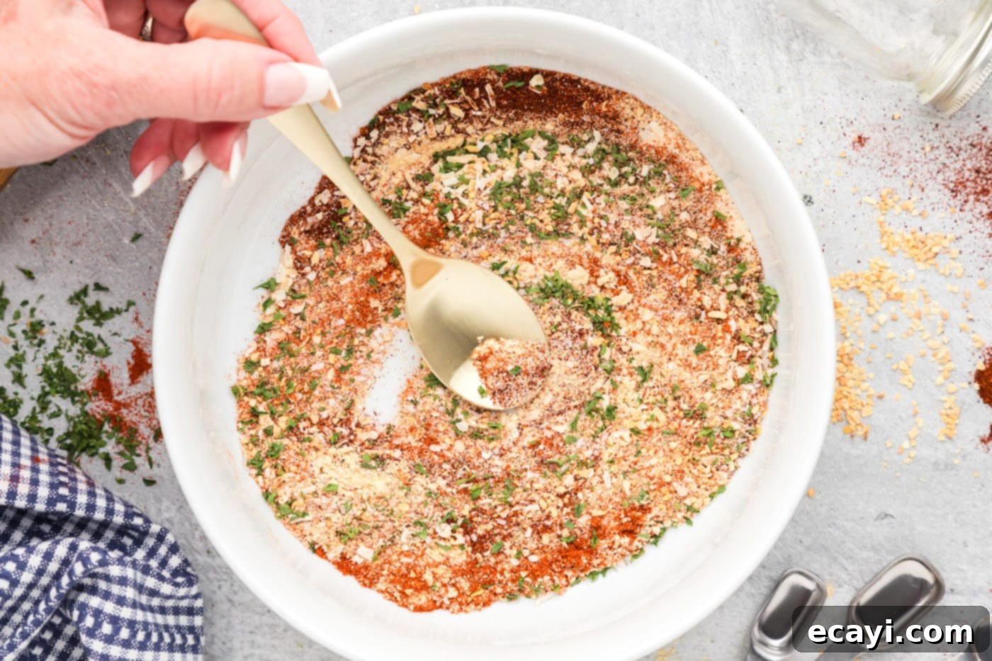 Everyday Seasoning 6 spoon mixing spices together in a bowl
