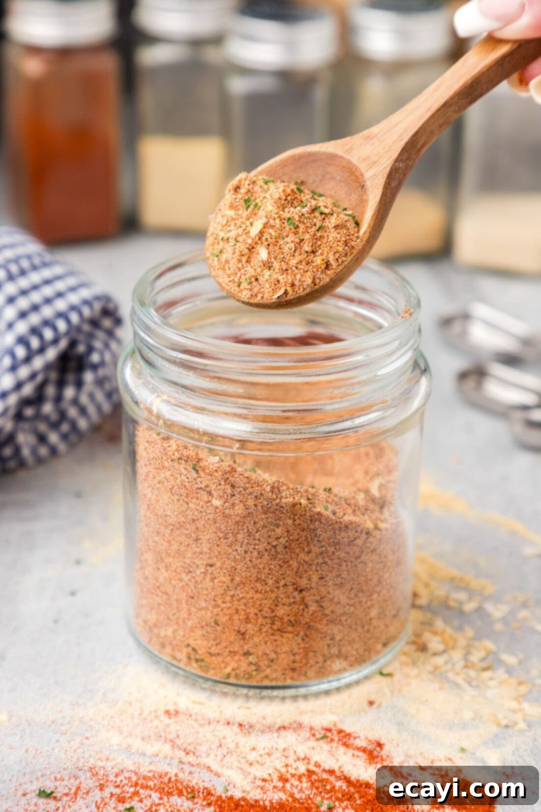 Everyday Seasoning 7 Spoonful of All Purpose Seasoning being lifted out of a jar of All Purpose Seasoning