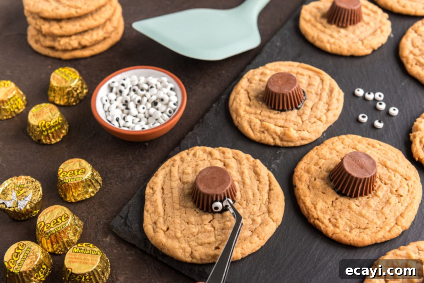 Spooky Spider Cookies 14 sticking candy eyeballs to peanut butter cup
