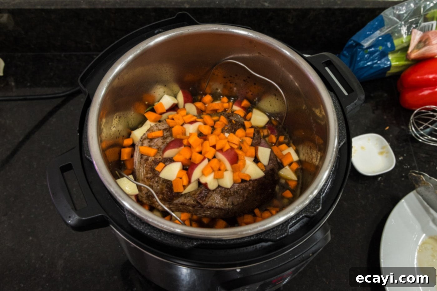 Effortless Instant Pot Roast Beef 12 carrots and potatoes added to instant pot with roast beef