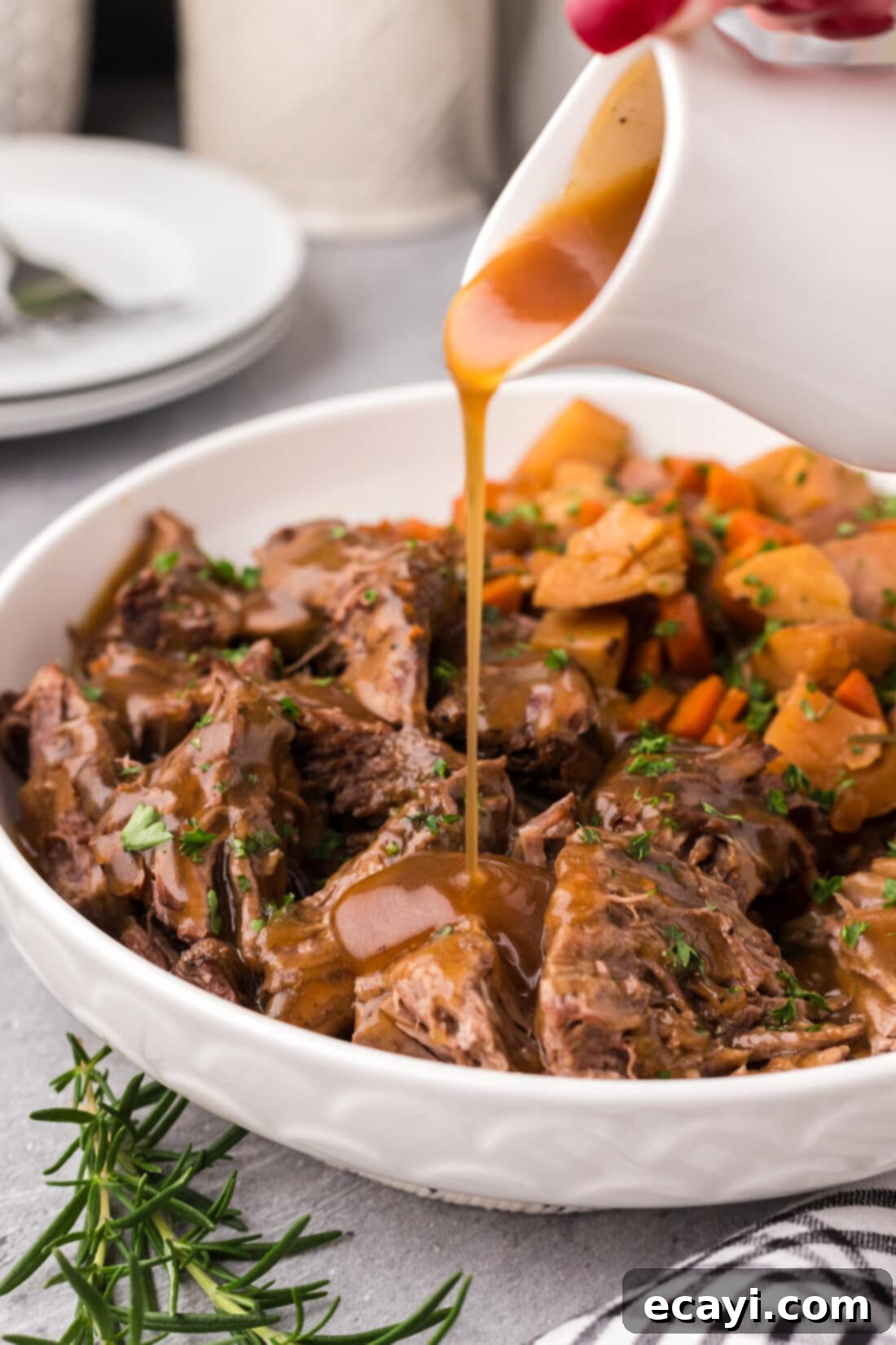 Effortless Instant Pot Roast Beef 13 Gravy being poured over Instant Pot Roast Beef