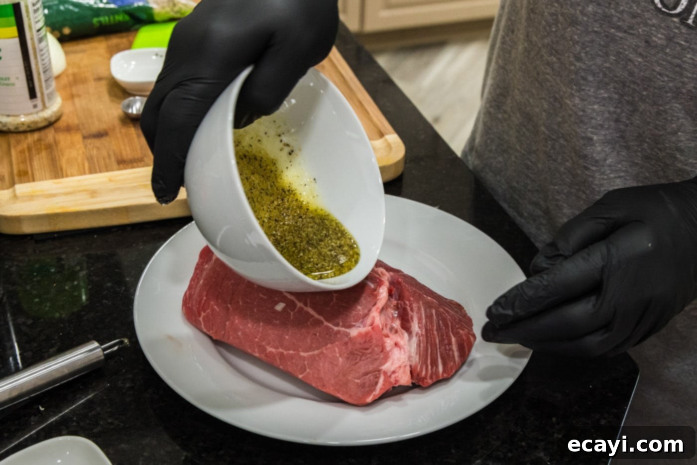Effortless Instant Pot Roast Beef 5 pouring wet rub on top of sirloin tip roast