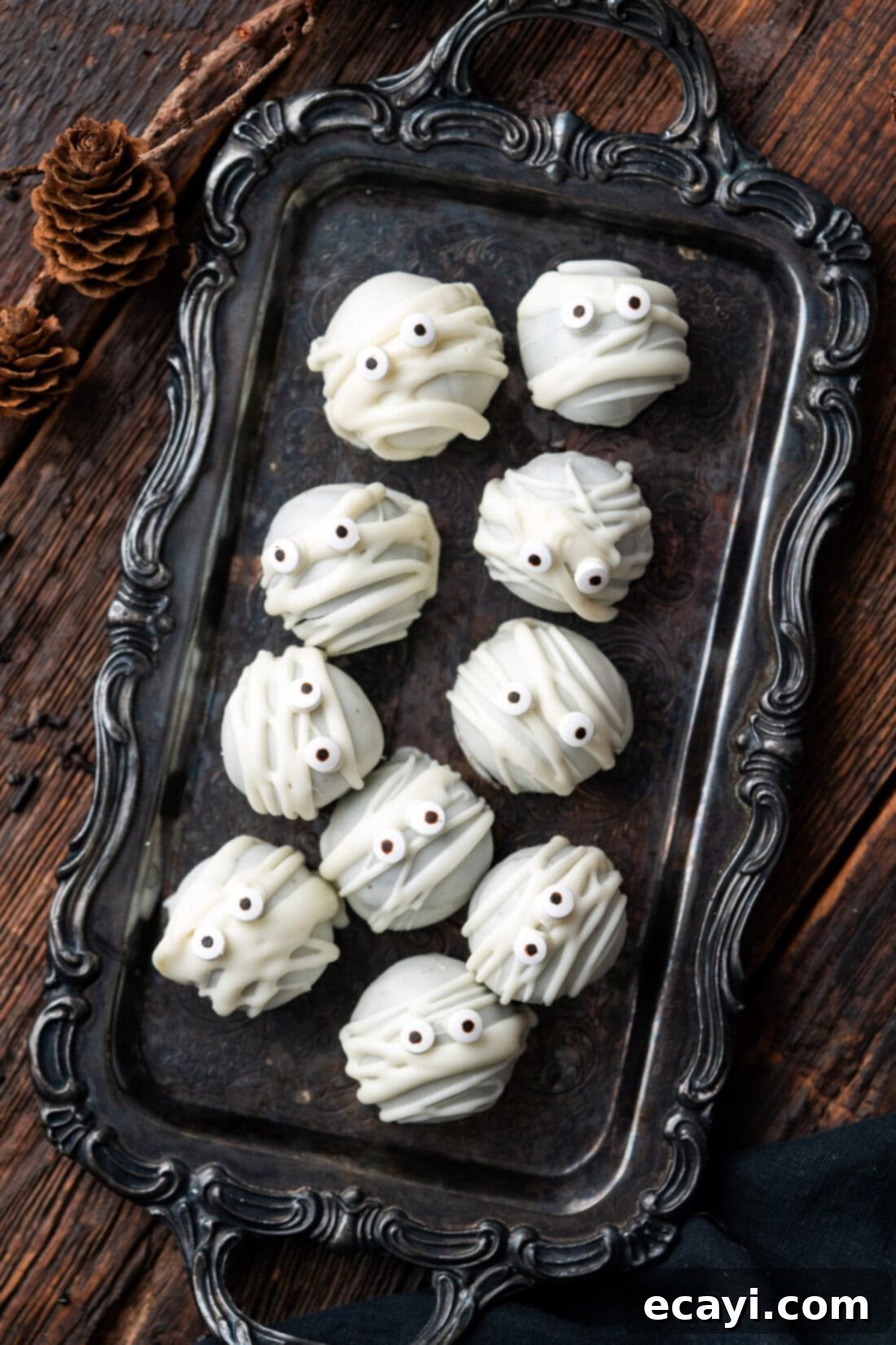 Wicked Oreo Wonders 2 Mummy Oreo Truffles on a black tray, showcasing an easy Halloween dessert