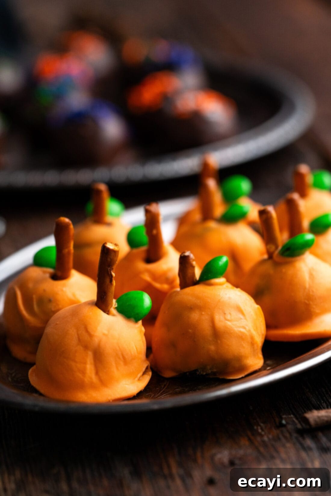 Wicked Oreo Wonders 3 Close up photo of pumpkin oreo truffles on a platter, showcasing vibrant Halloween colors
