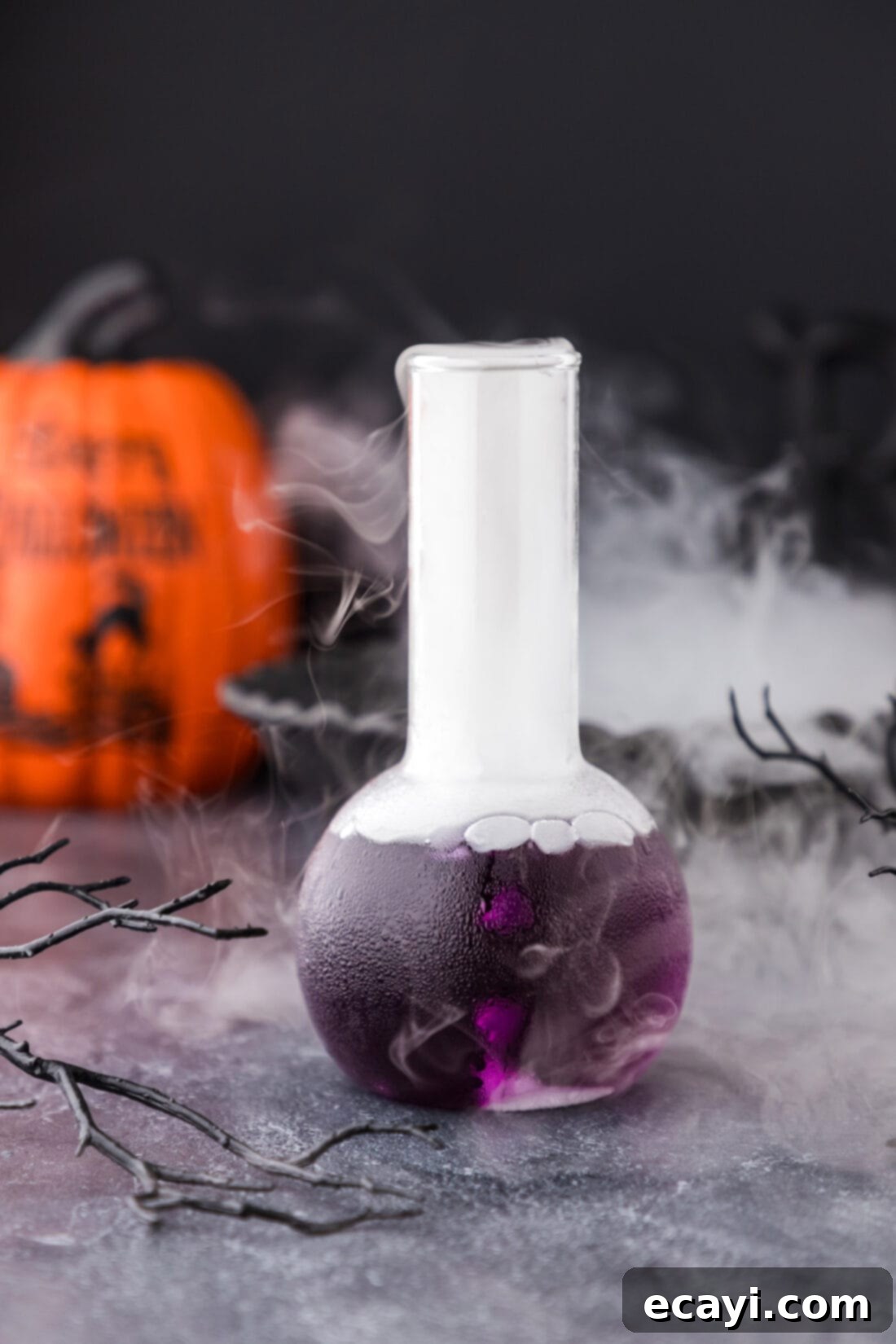 Amethyst Abyss Elixir 2 Purple People Eater Cocktail in a beaker glass with dry ice fog