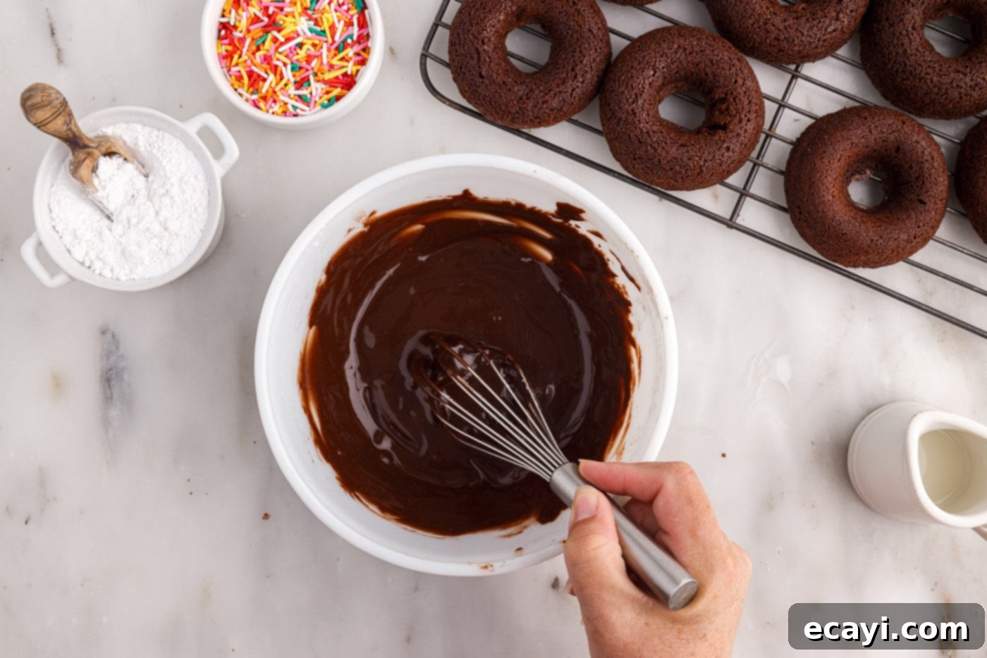 ChocoRings 15 whisking ingredients together to form a rich, smooth chocolate glaze in a bowl