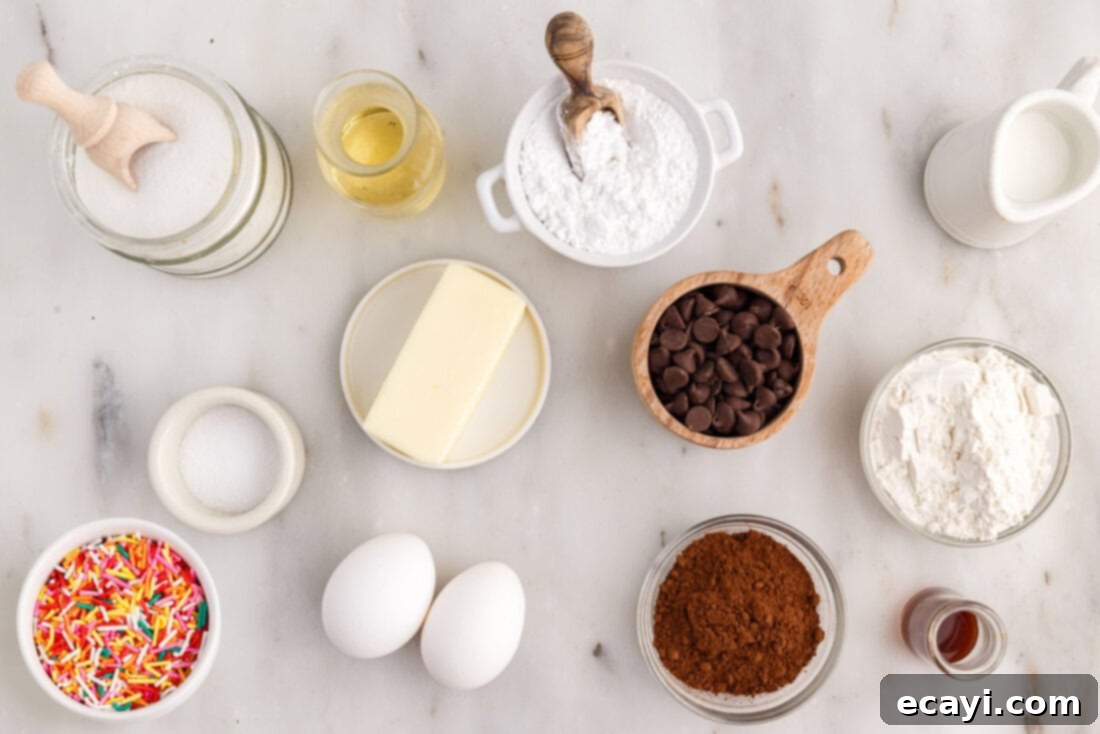 ChocoRings 4 All ingredients for baking Bronuts laid out on a kitchen counter, including butter, chocolate chips, sugar, eggs, flour, cocoa powder, milk, and powdered sugar