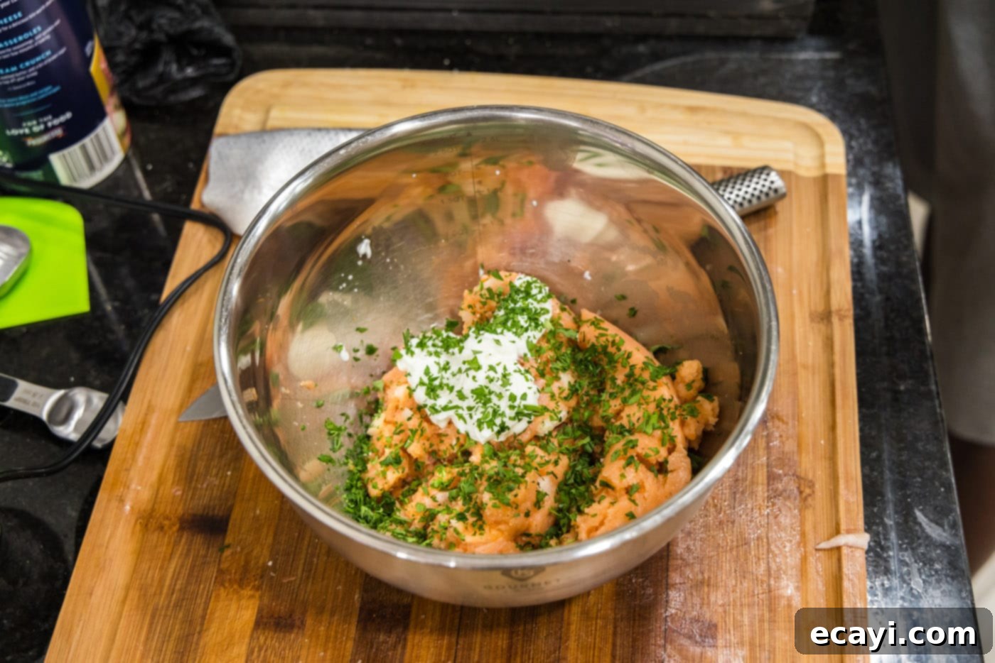 Delicious Salmon Burgers 7 Adding Greek yogurt to the blended salmon mixture in a bowl