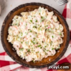 Lemon-Herb Shrimp Pasta Salad 12 A vibrant bowl of Creamy Shrimp Pasta Salad, garnished with fresh herbs, ready to be served.
