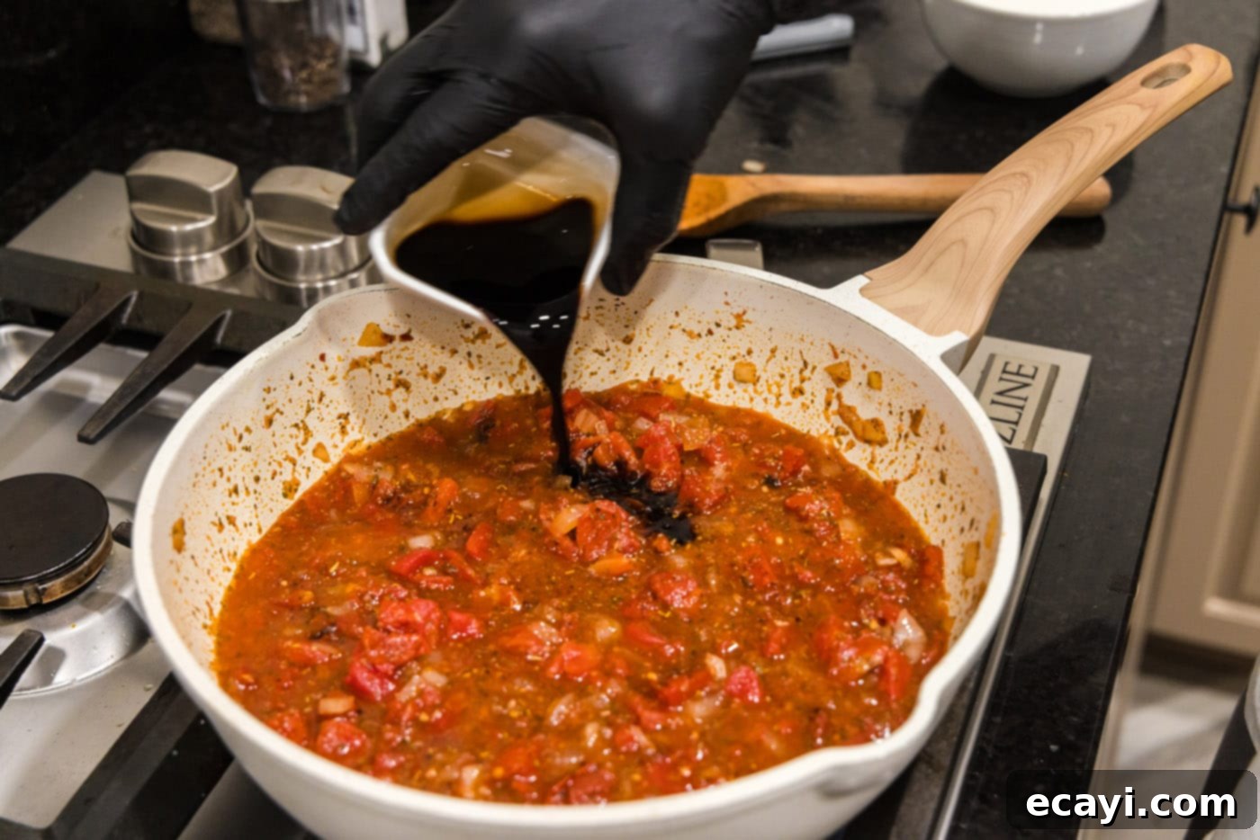 Creamy Vodka Pasta Sauce 10 pouring balsamic vinegar into the skillet with the evolving vodka sauce