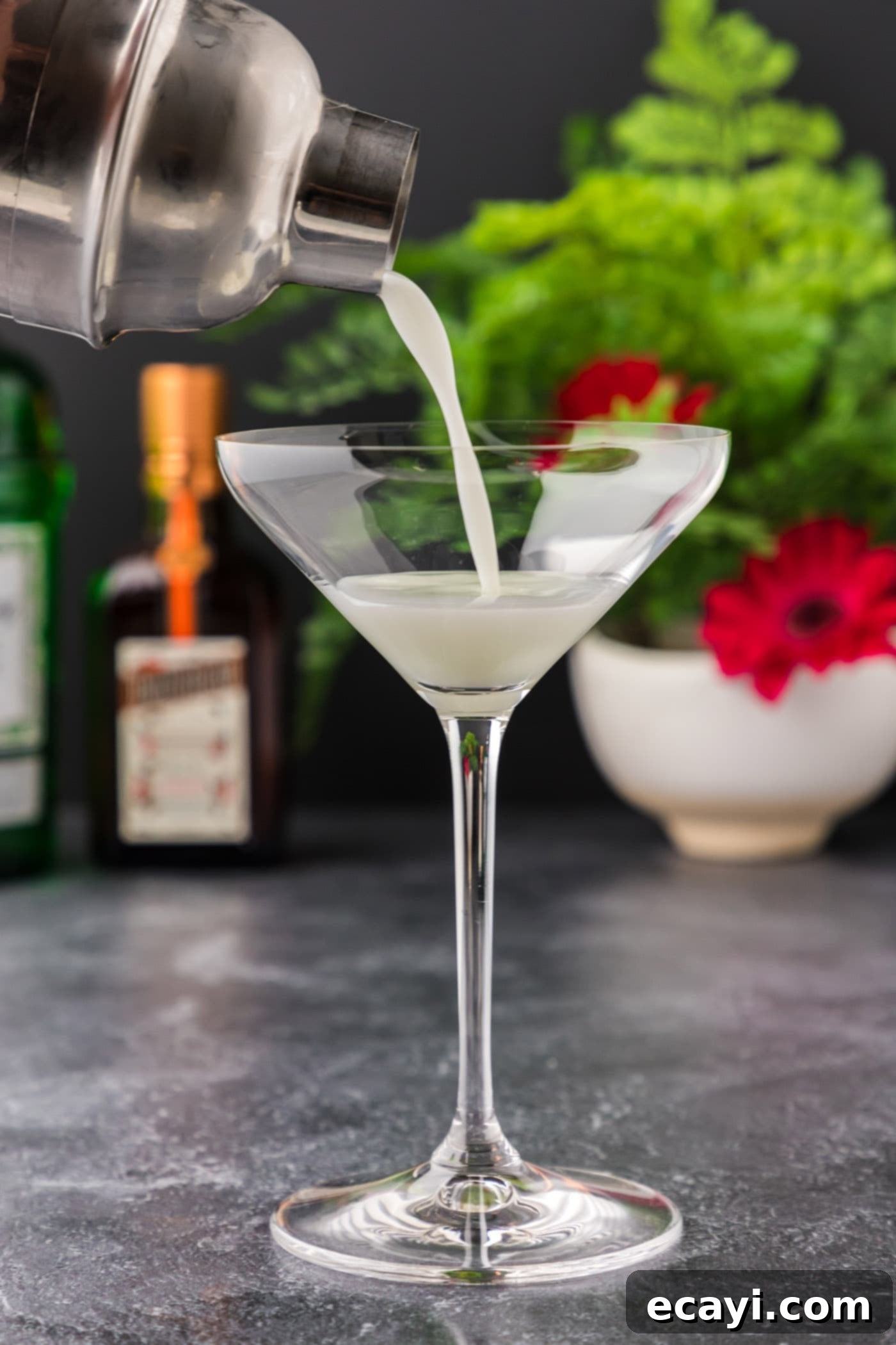 Moonlit Whisper 8 straining white lady cocktail into martini glass