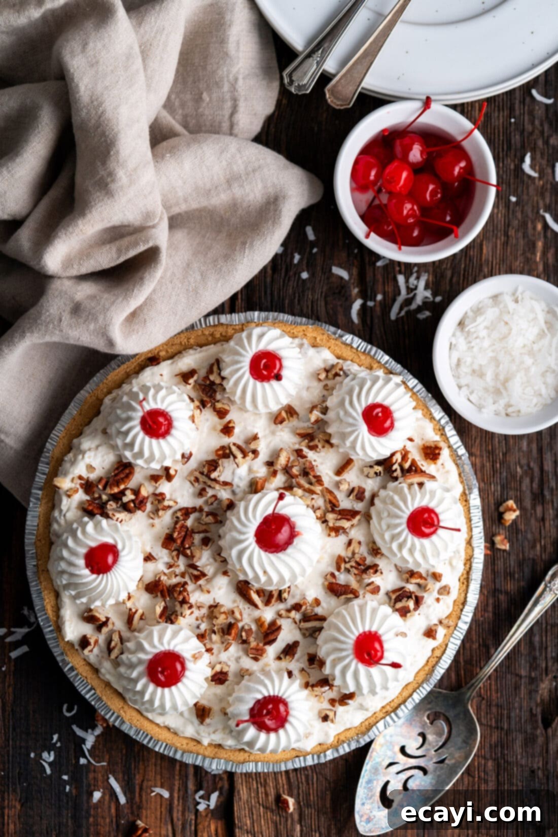 Decadent Dream Pie 2 Million Dollar Pie with a bowl of cherries and shredded coconut on the side