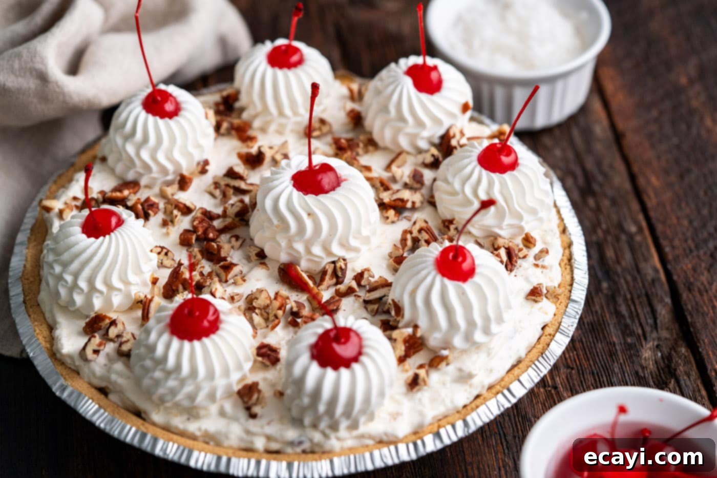 Decadent Dream Pie 12 piped cool whip and maraschino cherries on top of million dollar pie