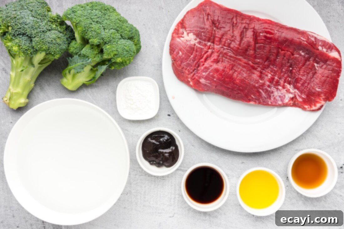 Delicious Instant Pot Beef and Broccoli 4 A flat lay photograph displaying all the fresh and pantry ingredients required to make Instant Pot Beef and Broccoli, including flank steak, broccoli, soy sauce, garlic, and other seasonings.