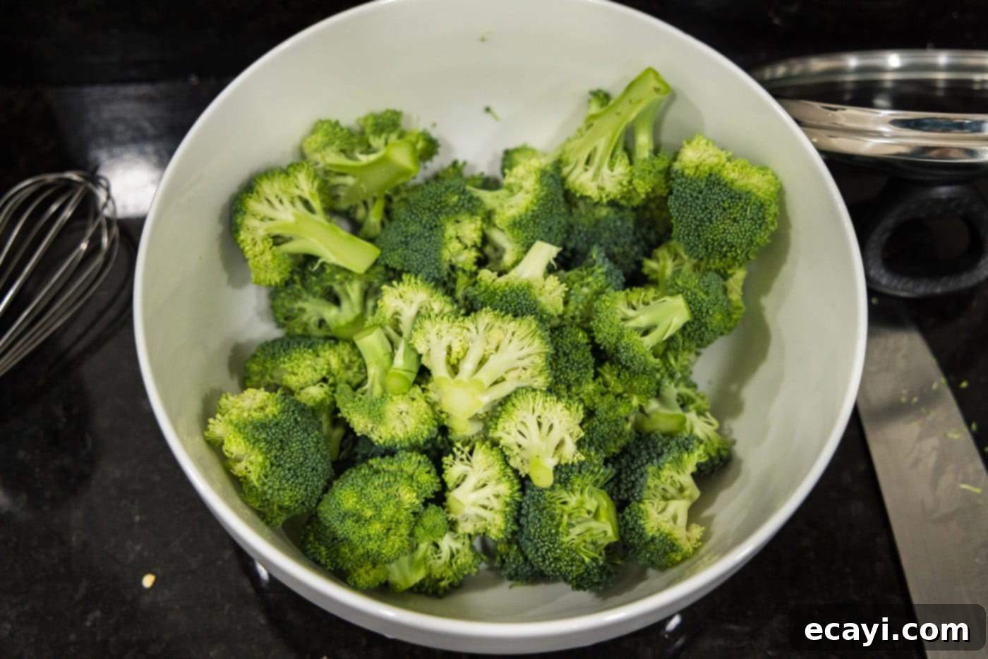 Delicious Instant Pot Beef and Broccoli 6 Fresh broccoli crowns beautifully cut into large, uniform florets on a clean cutting board, ready for the Instant Pot.