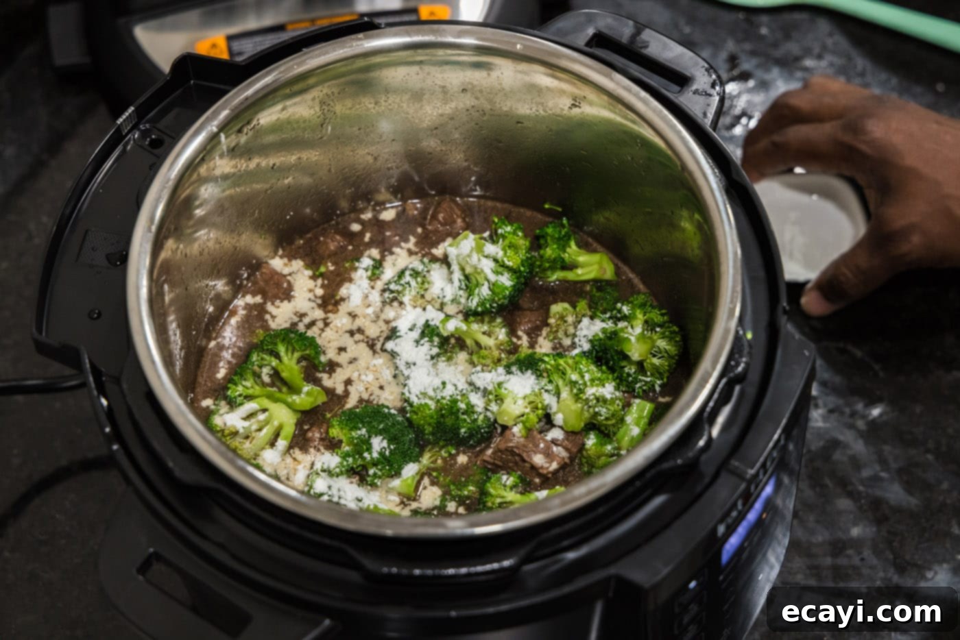 Delicious Instant Pot Beef and Broccoli 9 Fresh broccoli florets generously sprinkled with cornstarch, ready to be sautéed in the Instant Pot alongside the beef.
