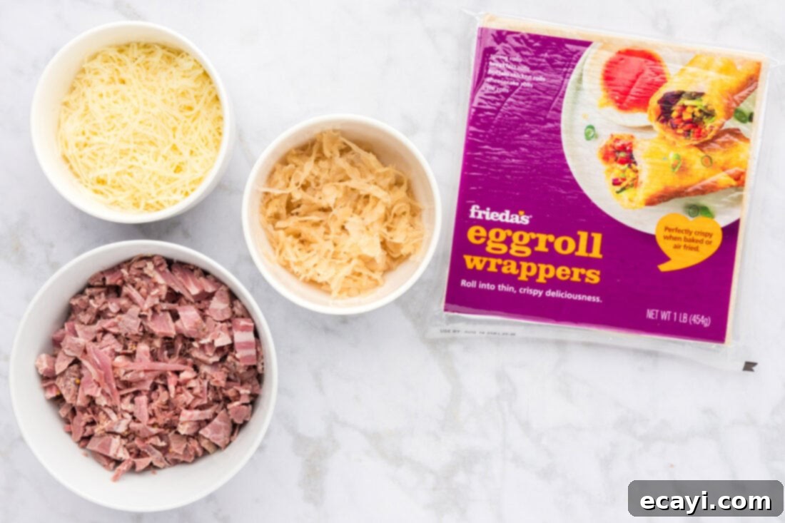 Crispy Reuben Egg Rolls 4 All the core ingredients laid out for making Reuben Egg Rolls: egg roll wrappers, a bowl of sauerkraut, chopped corned beef, and shredded Swiss cheese.