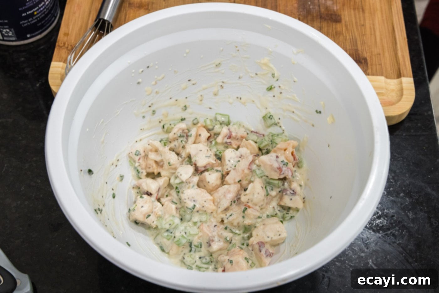 Chilled Lobster Cucumber Canoes 8 All lobster salad ingredients — succulent lobster, crisp celery, fresh chives, and creamy dressing — perfectly combined in a mixing bowl, creating a rich and flavorful mixture with beautiful texture.