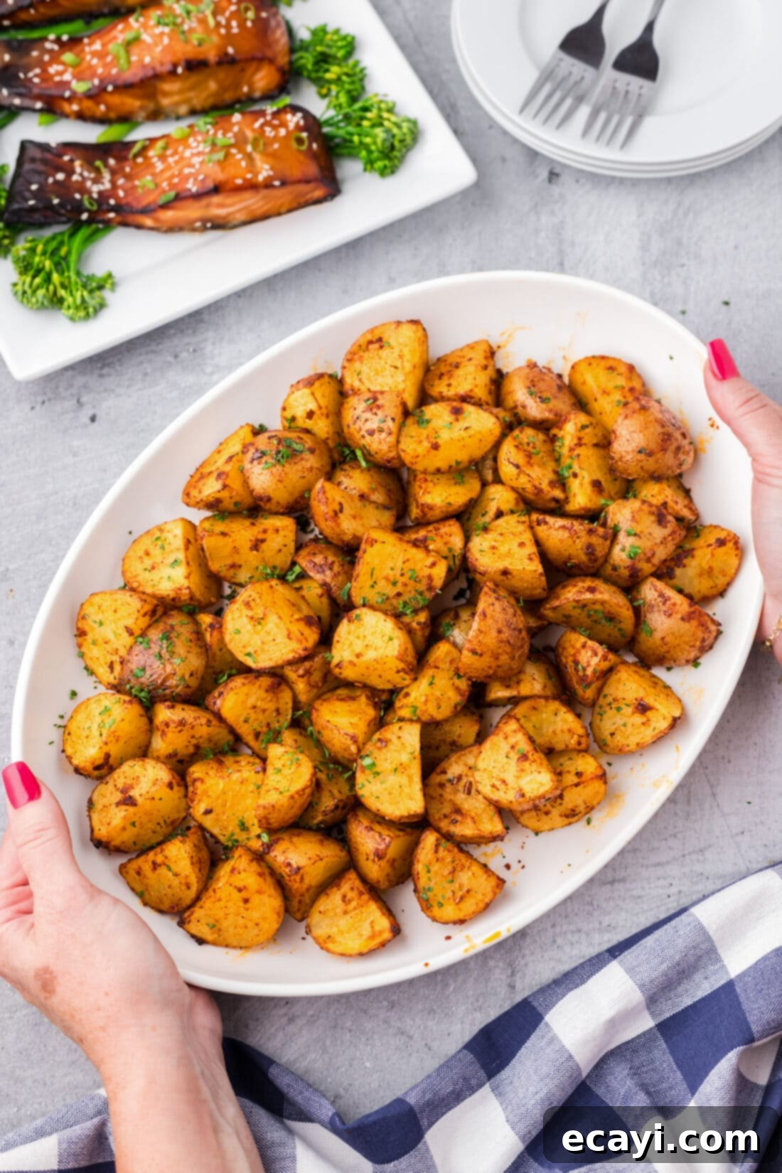 Fiery Roasted Potatoes 2 Hands holding a platter of Spicy Potatoes