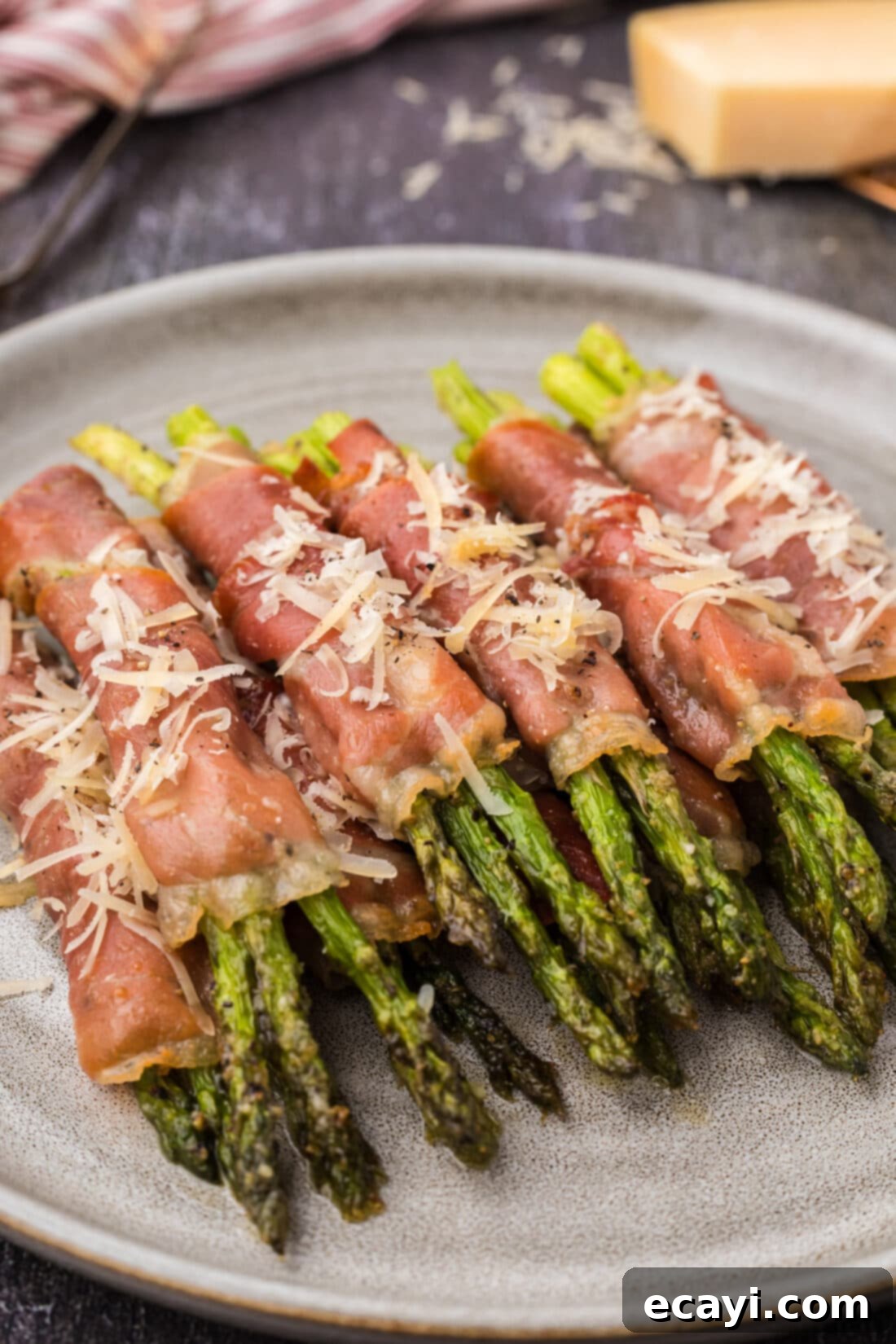 Crispy Prosciutto-Wrapped Asparagus 2 Prosciutto Wrapped Asparagus stacked on a plate
