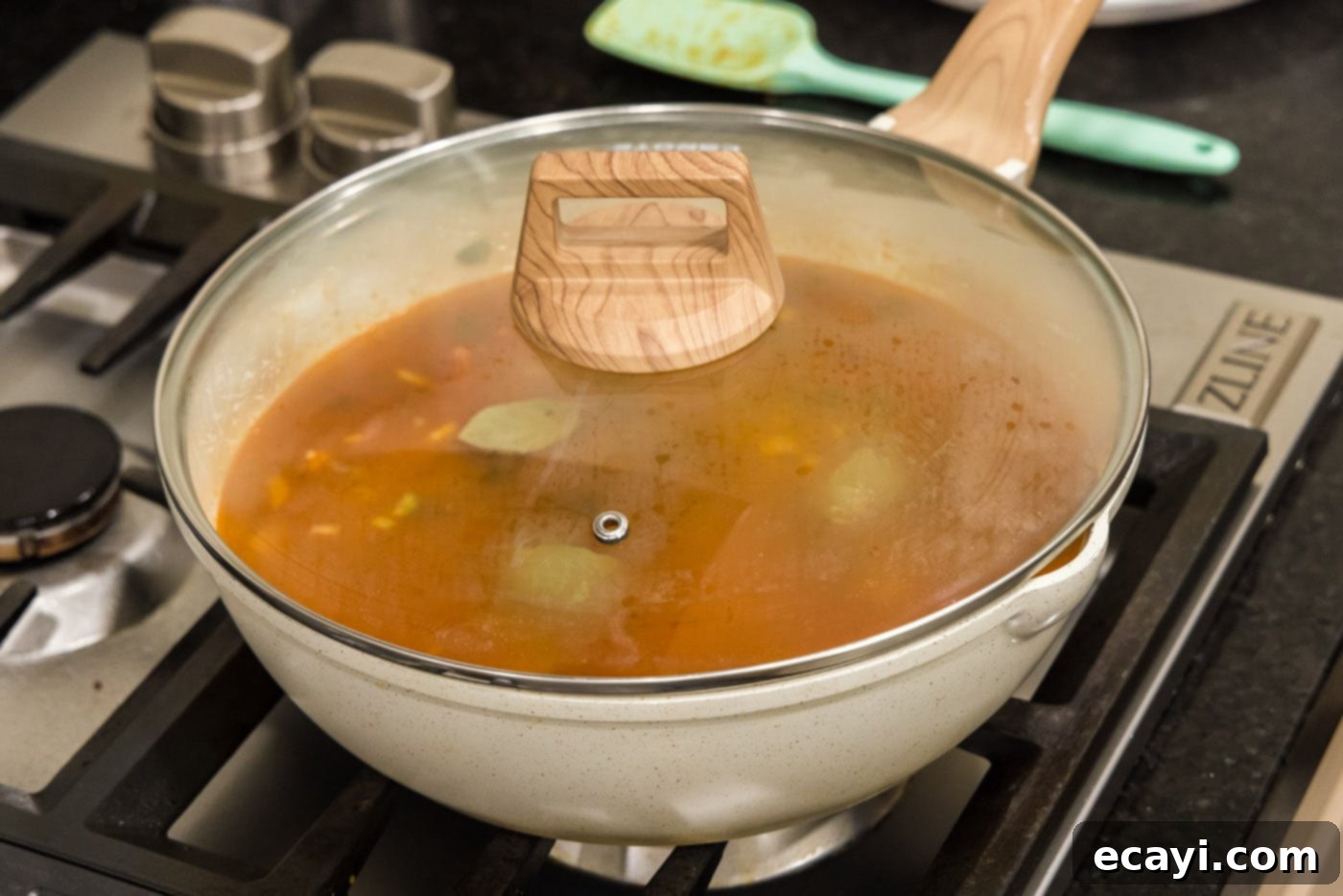 Hearty Louisiana Red Beans and Rice 11 simmering red bean mixture in skillet with a lid, allowing flavors to meld