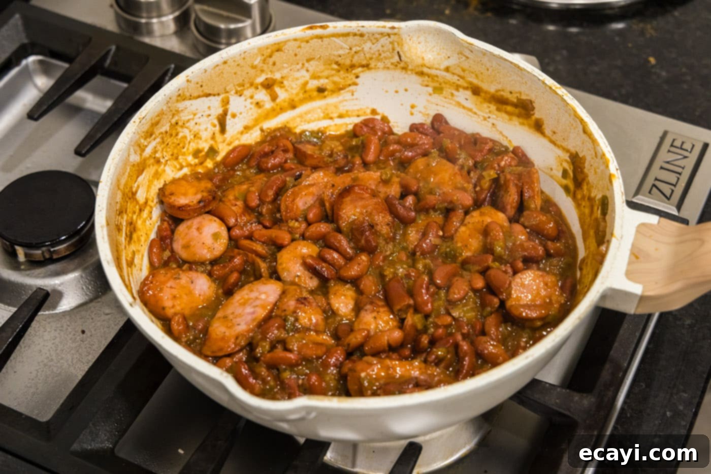 Hearty Louisiana Red Beans and Rice 13 sliced andouille sausage combined with cajun red beans in a skillet