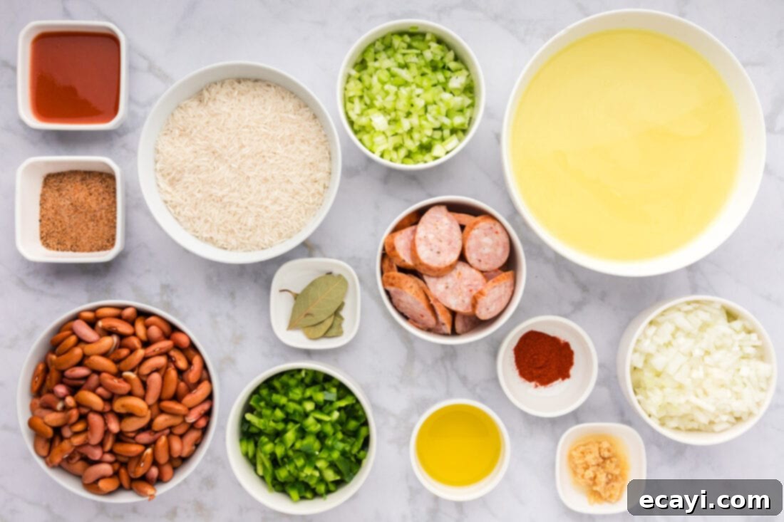 Hearty Louisiana Red Beans and Rice 4 A collection of fresh ingredients laid out for Cajun Red Beans and Rice, including sausage, beans, and vegetables