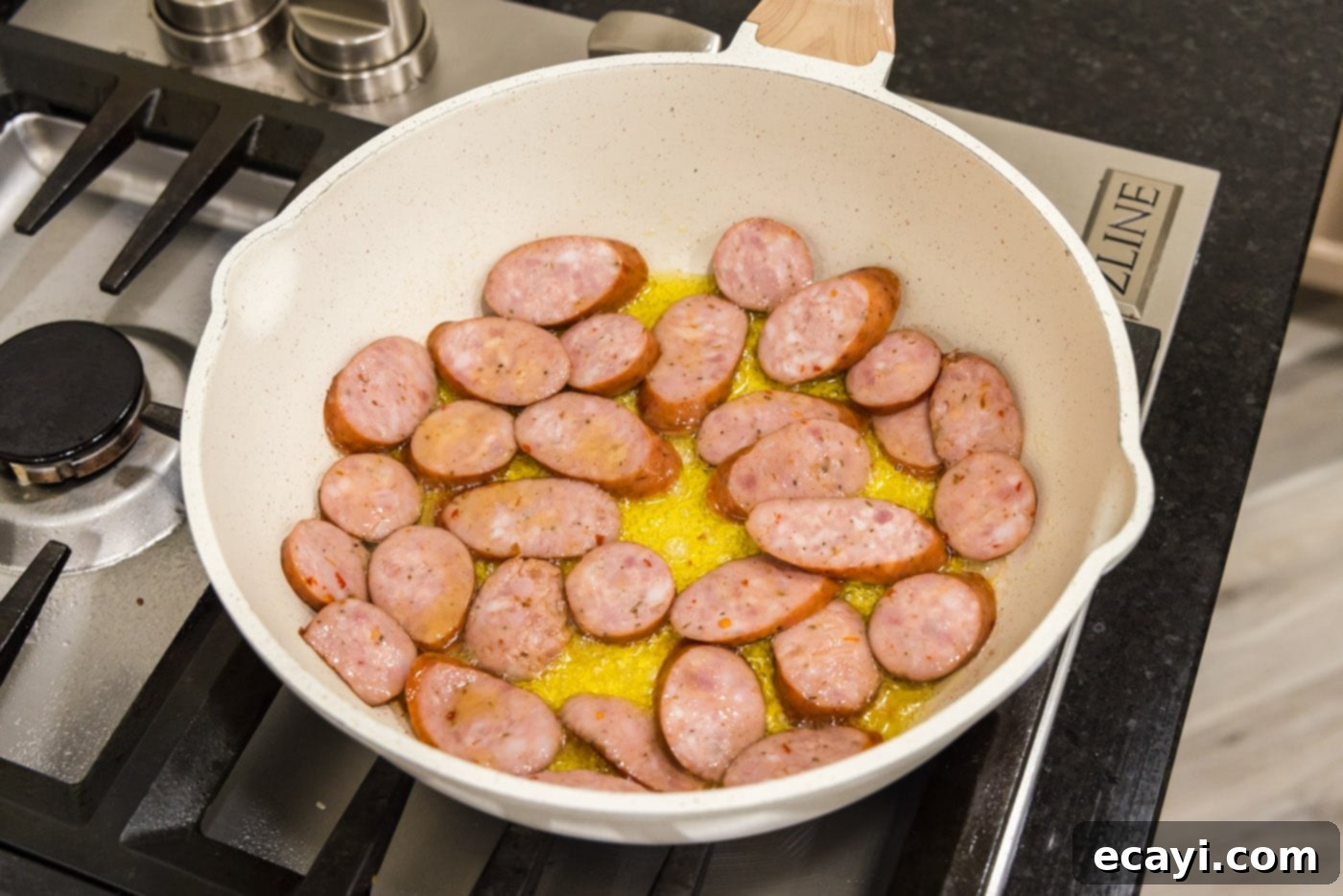 Hearty Louisiana Red Beans and Rice 5 sliced andouille sausage sizzling in a skillet with oil