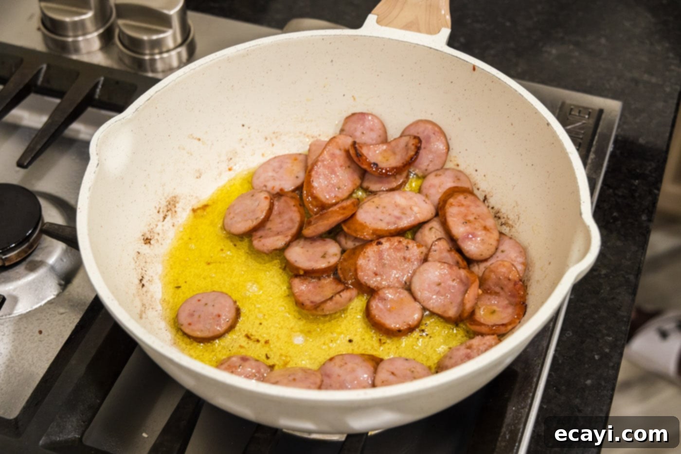 Hearty Louisiana Red Beans and Rice 6 cooking andouille sausage browning in a skillet with oil