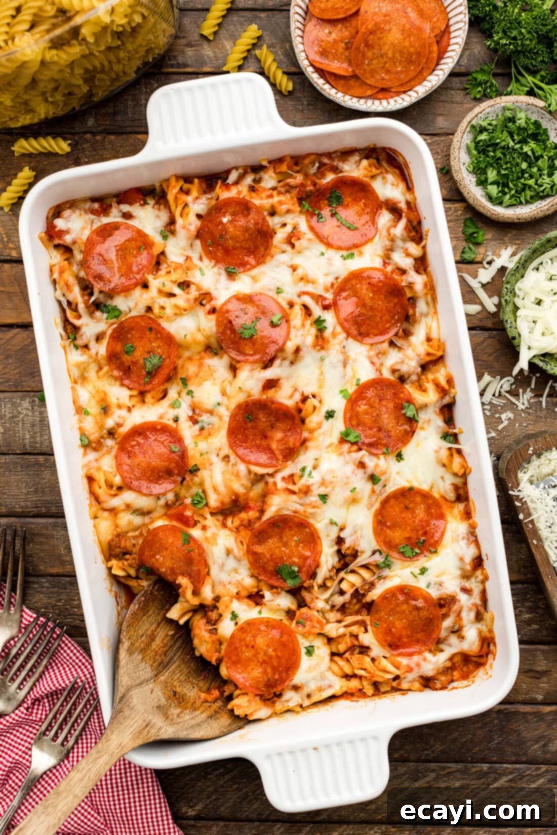 Ultimate Sausage and Pepperoni Pizza Bake 2 Serving spoon resting in a Sausage & Pepperoni Pizza Casserole