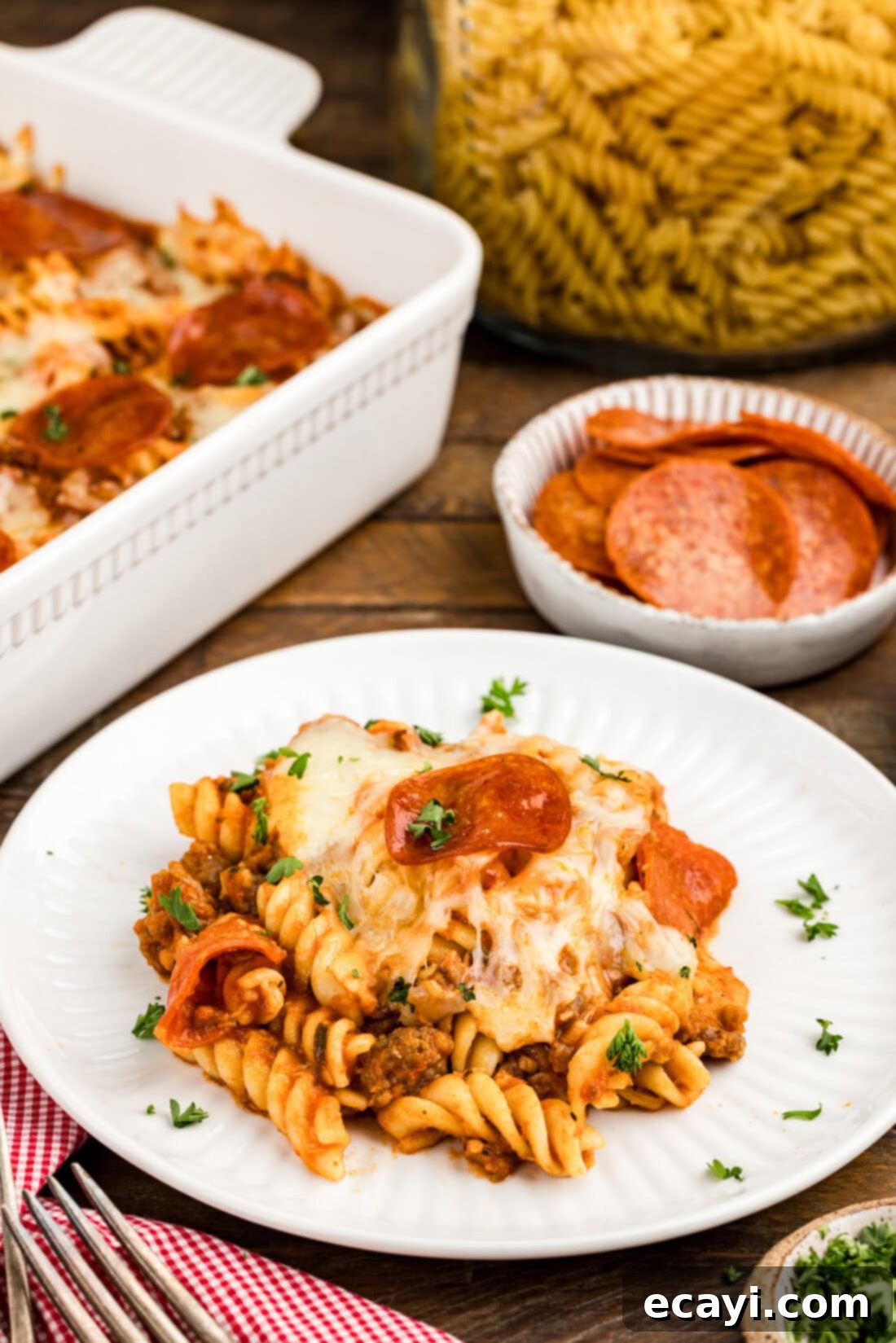 Ultimate Sausage and Pepperoni Pizza Bake 11 Serving of Sausage & Pepperoni Pizza Casserole on a white plate