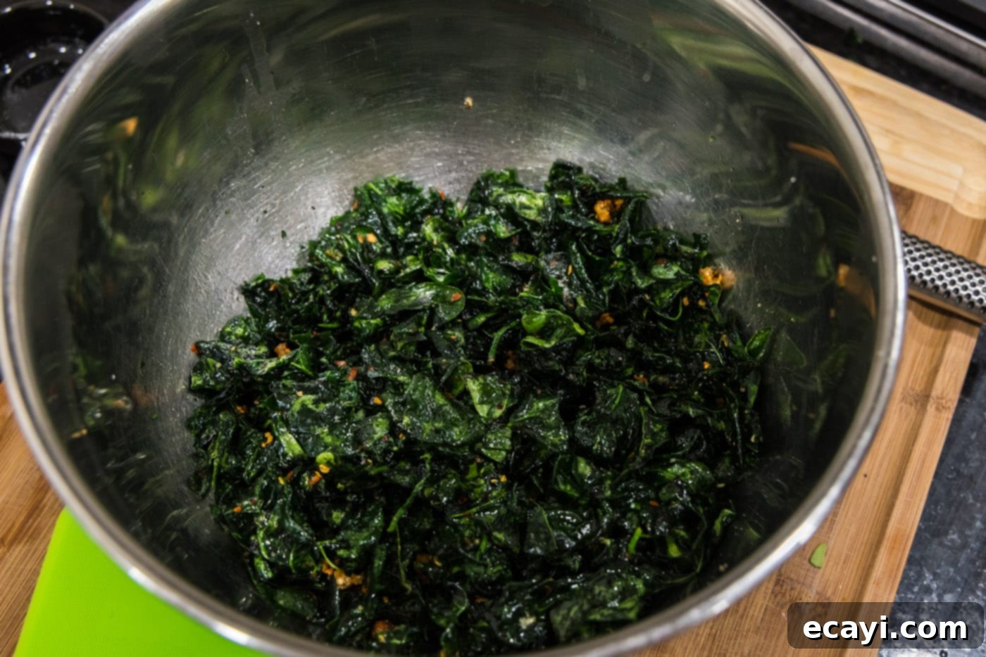 Crispy Spinach Sauté 12 A bowl of freshly tossed crispy fried spinach with garlic and red pepper flakes, ready to serve.
