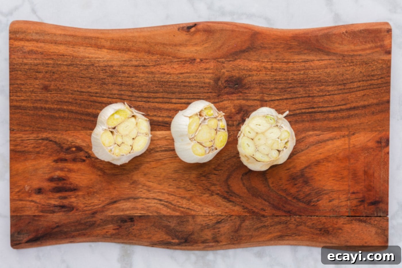 Roasting Garlic Made Easy 5 garlic bulbs with the tips sliced off